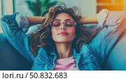 Calm woman in eyeglasses and denim, unwinding comfortably indoors with soft, ambient illumination. Стоковое AI-видео, аниматор Данила Большаков / Фотобанк Лори
