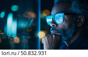Contemplation at Night: A Man lost in thought Reflects on City Lights from a High-Rise Window, Seeking Inspiration for Tomorrow. Стоковое AI-изображение, AI-художник Данила Большаков / Фотобанк Лори