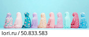 Ramadan Concept: Row of women in prayer garb, vibrant pastel palette, for spiritual reflection posters and religious observance. Стоковое AI-изображение, AI-художник Данила Большаков / Фотобанк Лори