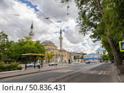 Yevpatoria, Russian Federation - July 05, 2025: Historic mosque with tall minarets and lush greenery, set against a cloudy sky in a vibrant urban landscape. Редакционное фото, фотограф Ирина Ручушкина / Фотобанк Лори