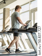 Athlete man running track, warming up on gym treadmill. Running at gym. Стоковое фото, фотограф Светлана Лажко / Фотобанк Лори