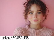 Portrait of a young woman with blue eyes and freckles on a pink background. Her gentle smile and soft sweater create an atmosphere of warmth, coziness and natural beauty. Perfect for themes about natural cosmetics, skin care, femininity, fashion and positivity. Modern style, harmonious pastel colors and expressive look make the image universal for advertising, blogs, magazines and social content. Стоковое AI-изображение, AI-художник Анна Кривицкая / Фотобанк Лори