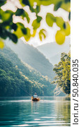 A serene escape: angling on the calm lake surrounded by majestic mountains. Стоковое AI-изображение, AI-художник Данила Большаков / Фотобанк Лори