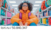 Back To School: Portrait of a girl with curly hair and glasses with school supplies in the shop, for marketing, web, education and print purpose. Стоковое AI-изображение, AI-художник Данила Большаков / Фотобанк Лори