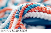 Intertwined Cordage: A Macro Study in Blue, Coral and White. Стоковое AI-изображение, AI-художник Данила Большаков / Фотобанк Лори