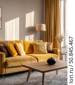 Modern cozy living room with mustard yellow sofa, sunlight shadows, and warm neutral decor, showcasing stylish interior design and natural light. Стоковое AI-изображение, AI-художник Катерина Бондарец / Фотобанк Лори