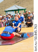 ELANTSY VILLAGE, IRKUTSK REGION, RUSSIA - July 5, 2025: Erdynskie Games - festival of nomadic peoples of Eurasia. Wrestlers compete in mas-wrestling - a national strength sport of pulling a wooden stick. Редакционное фото, фотограф Виктория Катьянова / Фотобанк Лори