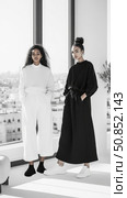 Monochromatic Elegance: Two Women in Contrasting Outfits, a Modern Interpretation of Yin and Yang for fashion editorial. Стоковое фото, фотограф Данила Большаков / Фотобанк Лори