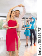 Woman enjoying merengue with male partner in latin dance class. Стоковое фото, фотограф Яков Филимонов / Фотобанк Лори