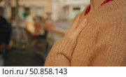 Person practicing mindful breathing outdoors with hand resting gently on chest. Стоковое видео, видеограф Igor Tichonow / Фотобанк Лори