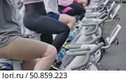 Group of People Exercising on Stationary Bikes. Стоковое видео, видеограф Mikhail Davidovich / Фотобанк Лори
