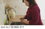 Senior active woman cooking lunch at home in modern kitchen. Healthy eating, food and culinary concept. Hands of old lady with knife chopping vegetables, grating carrots. Elderly female cook a soup. Стоковое видео, видеограф Марина Демидюк / Фотобанк Лори
