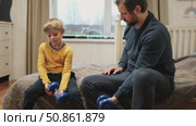 Caucasian bearded strong father with one child boy doing push ups on floor in living room. Family fitness gym at home. Sporty dad and son piggy back having fun exercise. Funny sport with kid. 4k video. Стоковое видео, видеограф Марина Демидюк / Фотобанк Лори
