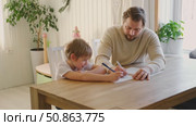 Dad teaches his son writing and counting. Kids primary education. Children learn, study in home school. Daddy male helping teaching little child boy support studying, learning homework. Knowledge day. Стоковое видео, видеограф Марина Демидюк / Фотобанк Лори