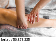 Natural medicine, reflexology, woman getting calf massage, depressing energy points, spa center, calm interior. Стоковое фото, фотограф Владислав Тригуб / Фотобанк Лори