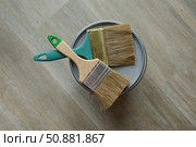 In the center are two paintbrushes lie on the top of the jar with paint. Laminated grey background. Repair concept, repair goods stores. Top down view. Copy space. Стоковое фото, фотограф Екатерина Топорова / Фотобанк Лори