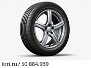 Car tire rotating on alloy wheel, showing tread and rim detail. Стоковое AI-изображение, AI-художник Иван Рябоконь / Фотобанк Лори