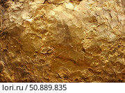 Golden textured surface with cracks and irregularities forming an intricate pattern. Стоковое AI-изображение, AI-художник Иван Рябоконь / Фотобанк Лори