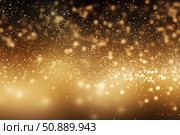 Golden particles falling and creating a festive atmosphere. Стоковое AI-изображение, AI-художник Иван Рябоконь / Фотобанк Лори