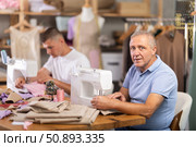 Elderly and young man sew on machine in workshop. Стоковое фото, фотограф Яков Филимонов / Фотобанк Лори