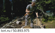 Worker Splitting Firewood with Splitting Axe in Forest - Traditional Wood Chopping and Log Splitting on Tree Stump - Manual Timber Processing in Woodland outdoor wood chopping, summer countryside day. Стоковое видео, видеограф Сергей Тимофеев / Фотобанк Лори