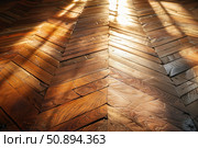 Sunlight illuminating herringbone pattern on antique wooden floor. Стоковое AI-изображение, AI-художник Иван Рябоконь / Фотобанк Лори
