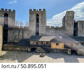View of a stone-paved courtyard enclosed by high fortified walls and several massive rectangular towers. Стоковое фото, фотограф Виктор Ветошкин / Фотобанк Лори