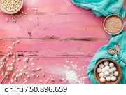 Ingredients for making tangyuan on pink wooden table with turquoise fabric. Стоковое AI-изображение, AI-художник Иван Рябоконь / Фотобанк Лори