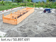 Construction site with wheelbarrow and spade on sand. Стоковое фото, фотограф Nobilior / Фотобанк Лори