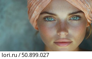 Intimate close-up of a woman with mesmerizing aqua eyes, a smattering of natural freckles, and a soft peach head covering. Стоковое AI-видео, аниматор Данила Большаков / Фотобанк Лори