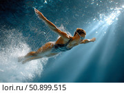 Diver gracefully plunges into water, showcasing athleticism and fluid motion in serene underwater scene. Стоковое AI-изображение, AI-художник Гайфуллина Дина / Фотобанк Лори