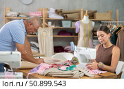 Girl master sew clothes in sewing machine, senior craftsman draw dress pattern. Стоковое фото, фотограф Яков Филимонов / Фотобанк Лори