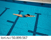Diver performing graceful springboard dive into clear blue swimming pool water. Стоковое AI-изображение, AI-художник Гайфуллина Дина / Фотобанк Лори