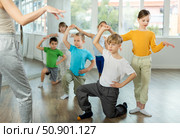 Girl paired up with boy, they train to perform slow waltz dance, rehearse performance. Стоковое фото, фотограф Яков Филимонов / Фотобанк Лори