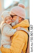 Concept: Intergenerational Bond, Grandfather and Granddaughter Embrace: Capturing a heartwarming moment of love and affection between generations. Стоковое AI-изображение, AI-художник Данила Большаков / Фотобанк Лори