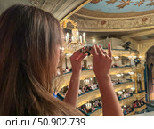 A girl with binoculars at the Mariinsky Theatre. June 8, Saint Petersburg, Russia. Редакционное фото, фотограф Луиза Налимова / Фотобанк Лори