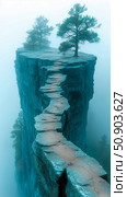 Serene path on a cliff edge with trees shrouded in mist. Стоковое AI-изображение, AI-художник Данила Большаков / Фотобанк Лори