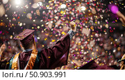 A group of graduates joyfully throwing confetti in the air to celebrate their academic achievement and mark the end of their educational journey. Стоковое AI-изображение, AI-художник Данила Большаков / Фотобанк Лори