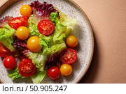 Vibrant salad from fresh lettuce and juicy cherry tomatoes in a ceramic bowl on a beige background. Tomato leafy greens salad with herbs and spices. Healthy food diet cuisine. Fresh nutrition plate. Стоковое AI-изображение, AI-художник Марина Демидюк / Фотобанк Лори
