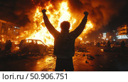 Silhouette of a man with his hands up against a large-scale city fire and riots at night. Bright flames engulfing cars and the street symbolize protest, revolution, chaos or anarchy. The atmosphere of tension and destruction, the frame is filled with dynamics and drama. The image is suitable for illustrating themes of social conflicts, civil unrest, crisis or freedom of expression. Стоковое AI-изображение, AI-художник Анна Кривицкая / Фотобанк Лори