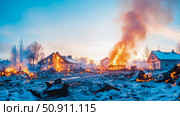 Conflagration scene, houses engulfed in fire, with snow covered ground and sky. Стоковое AI-изображение, AI-художник Данила Большаков / Фотобанк Лори