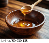 A spoon is scooping honey into a wooden bowl. Стоковое AI-изображение, AI-художник Ярославский Максим / Фотобанк Лори