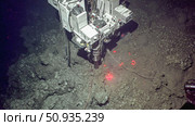 A deep sea mining robot operates on the ocean floor. Стоковое AI-изображение, AI-художник Евгения Пархоменко / Фотобанк Лори