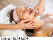 Young woman enjoying professional massage of neck, collarbone and chest. Стоковое фото, фотограф Яков Филимонов / Фотобанк Лори