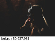 A man in a shirt holds his fingers on the sensual lips of a submissive lover. Portrait Woman in a leather cat mask. BDSM Games for adults. Стоковое фото, фотограф Михаил Решетников / Фотобанк Лори