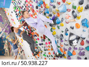 Woman training at bouldering gym without special climbing equipment. Стоковое фото, фотограф Яков Филимонов / Фотобанк Лори