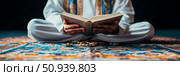 Ramadan Religious Observance: An individual engaged in Quran reading, seated on a prayer mat during a time of spiritual reflection. Стоковое AI-изображение, AI-художник Данила Большаков / Фотобанк Лори