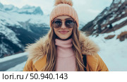 Winter Portrait of a Woman with a Pom-pom Hat and Sunglasses Against a Mountain Backdrop. Стоковое AI-изображение, AI-художник Данила Большаков / Фотобанк Лори