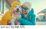 A heartwarming day: Woman and her dog cuddle, both are wearing clothes, with a playful, loving and affectionate mood. Стоковое AI-изображение, AI-художник Данила Большаков / Фотобанк Лори
