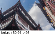 Ancient Chinese architecture. Fragments of buildings against the sky and clouds. Roofs with curved cornice edges. Barred windows. China. Shanghai. Yu Garden. Yuyuan. Стоковое фото, фотограф Вера Ивановна Кубарева / Фотобанк Лори